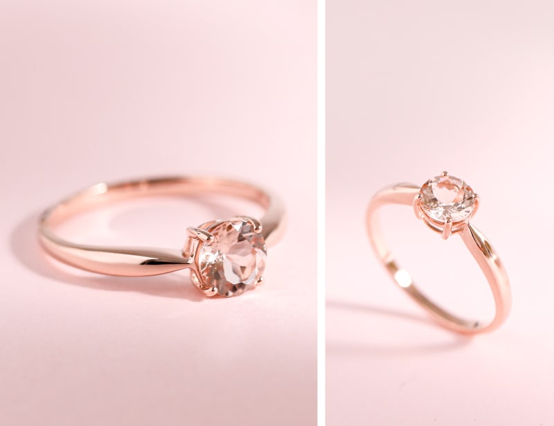 This is a close up image of a rose gold ring with a rose gold band and rose gold stone, photographed on a light pink background. 
