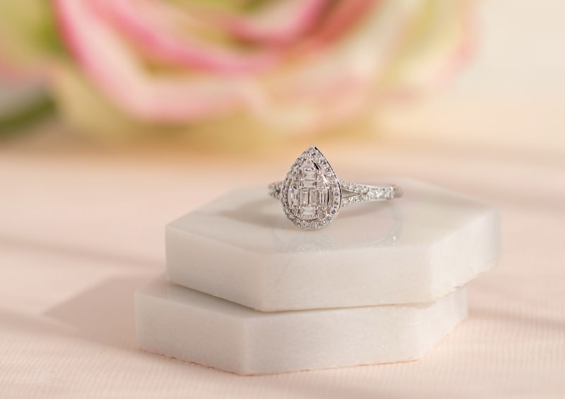 A pear shaped traditional diamond engagement ring. 