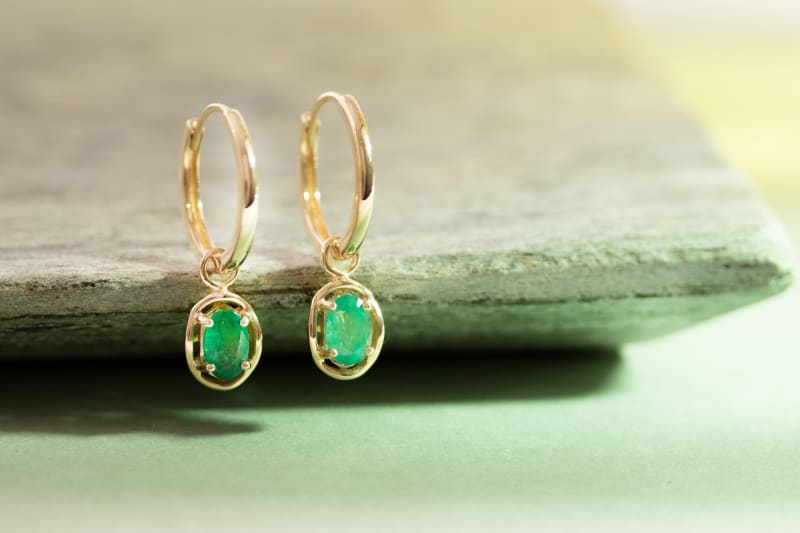 A pair of emerald green earrings. 
