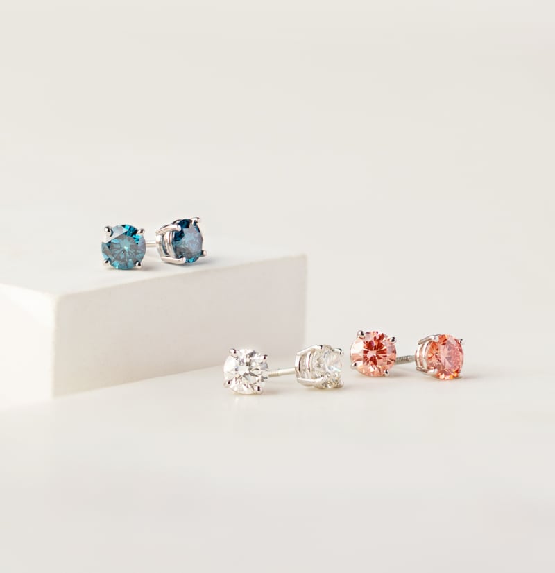 Three pairs of white, pink, and blue lab-grown diamonds  