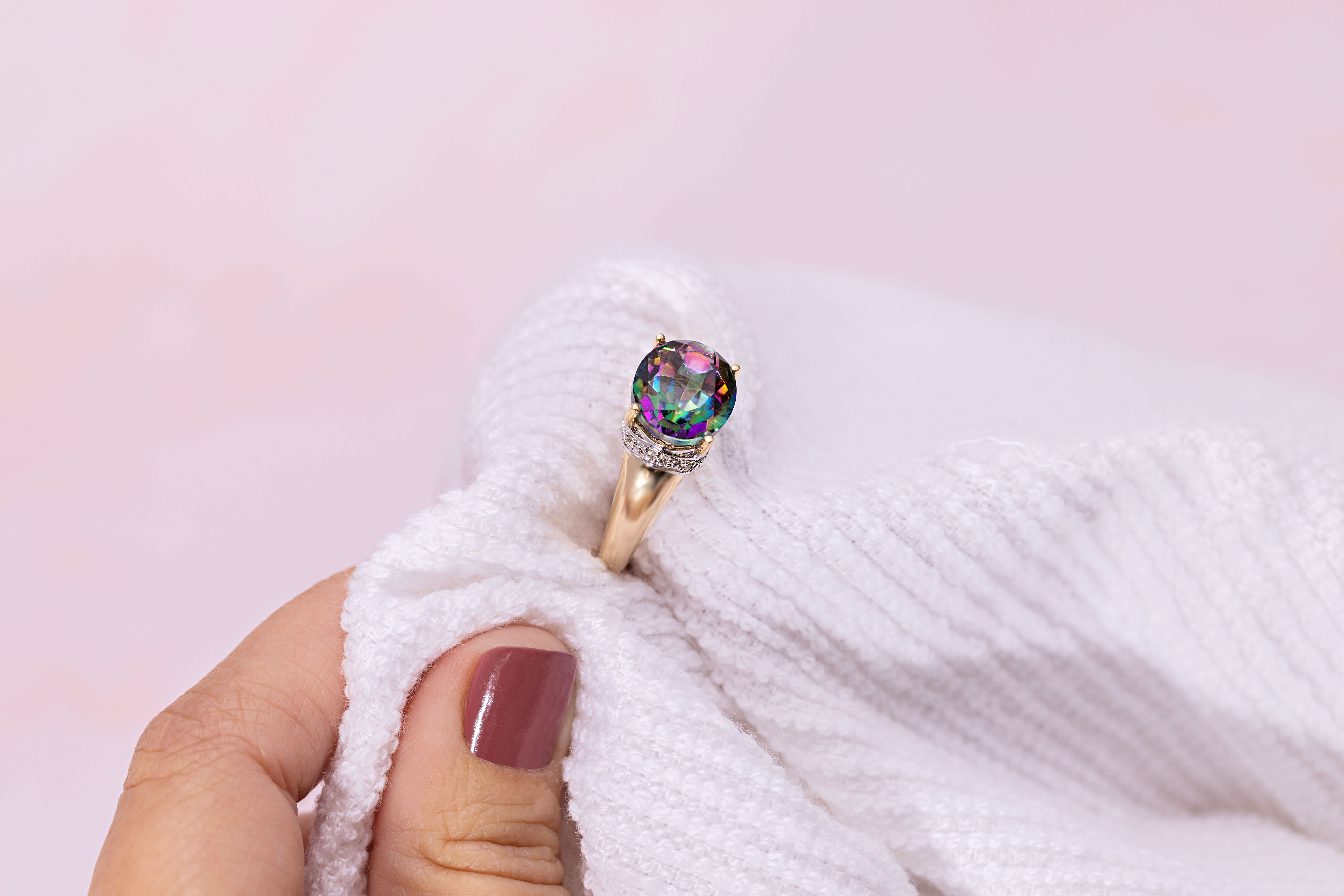 a multi-colored gemstone ring is dryed with cloth