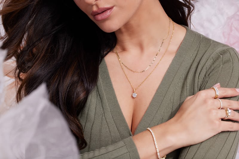 a ensemble of chic classic and gold necklaces and rings 