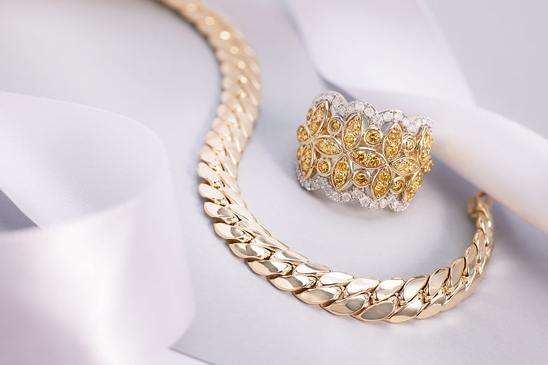 a luxurious, curb link bracelet and yellow and white diamond ring 
