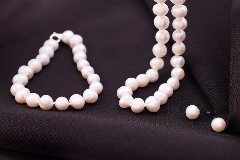 a white pearl strand bracelet and necklace 