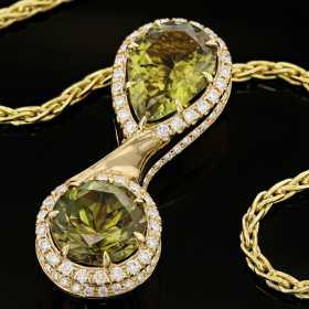 green gemstone necklace set in yellow gold
