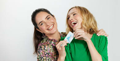 ladies laughing holding gift card