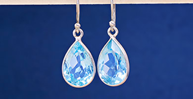 blue dangle earrings set in silver