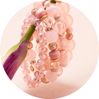 multiple pink beaded bracelets