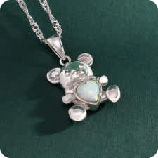 silver bear pendant with opal heart in the belly