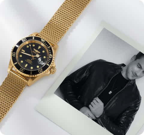 polaroid photo a man wearing jewelry with a gold watch laying next to it