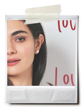 woman wearing pearl stud earrings