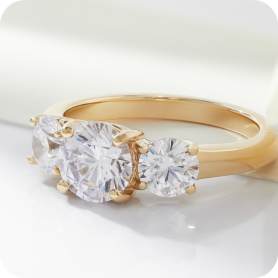 three stone engagement ring set in gold