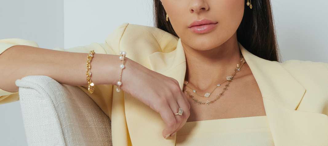 Woman wearing gold and pearl jewelry