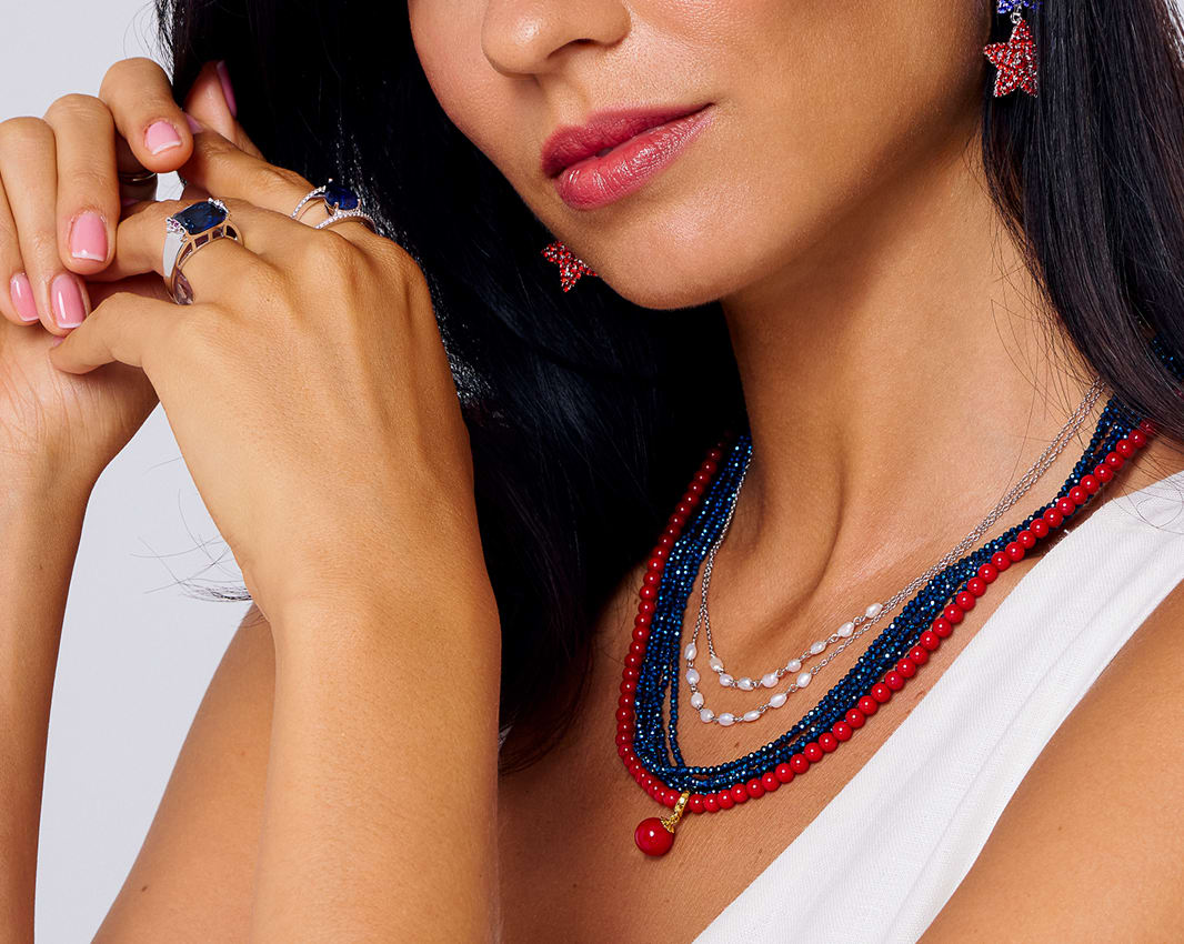 woman red, white and blue gemstone jewelry 