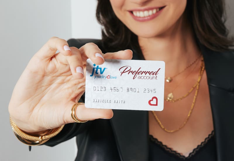 woman holding jtv preferred account card 