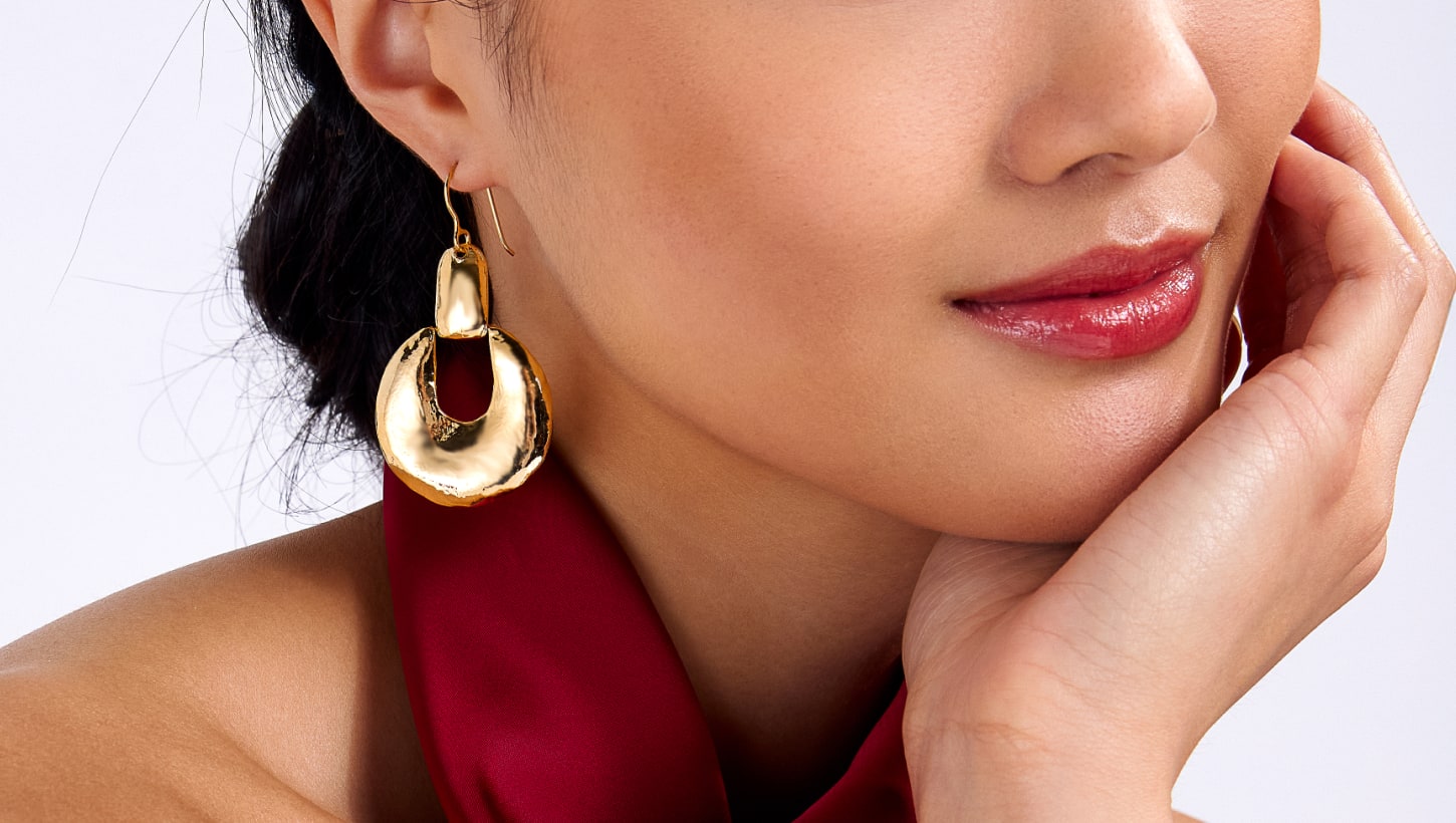 woman wearing gold earrings