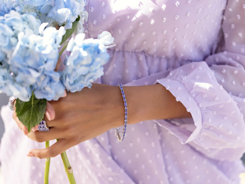 a model wears a tanzanite bracelet and multi-gem ring 