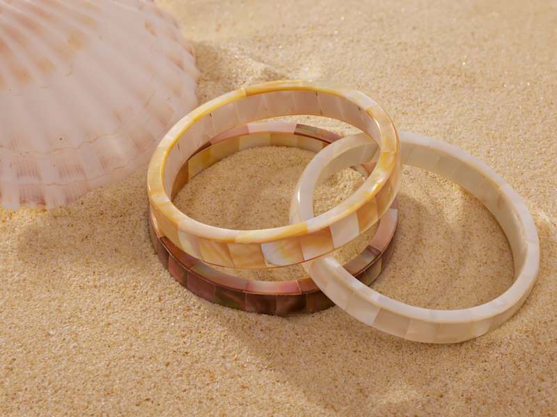 three different shades of mother of pearl bracelets 