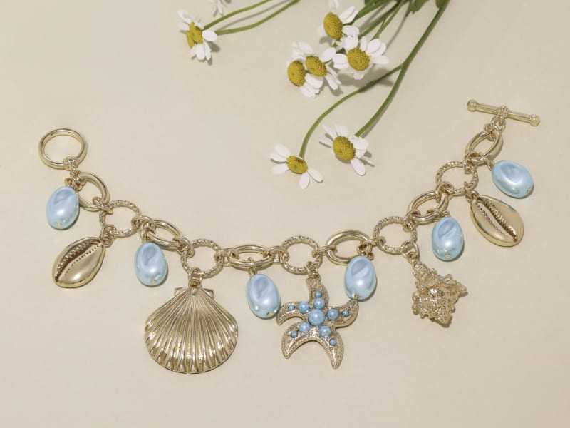 light blue gemstone and gold jewelry 
