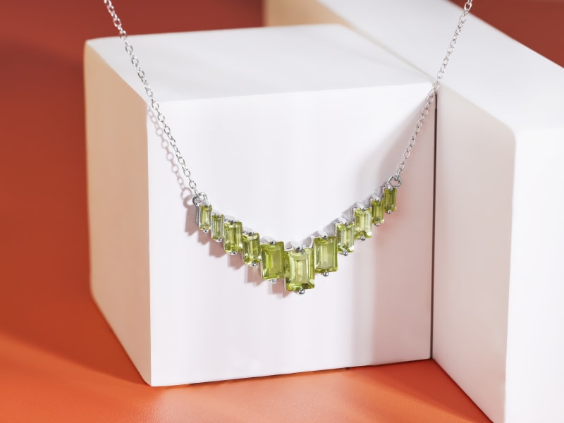 a bright green perdiot metal necklace 