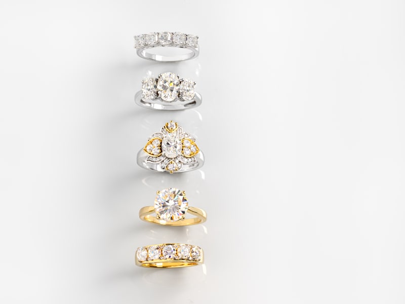a group of silver and gold, white gemstone rings 