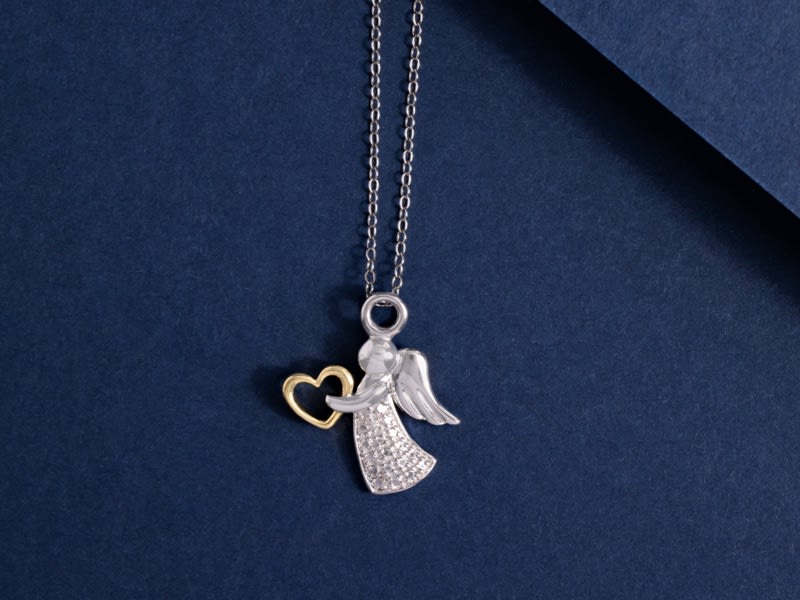 a silver angel and gold heart pendant necklace 