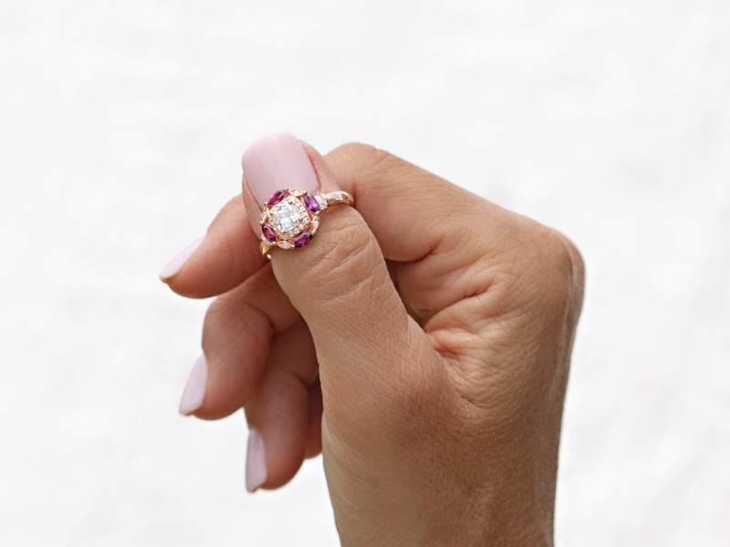 a round moissanite and oval grape-garnet rose gold ring 