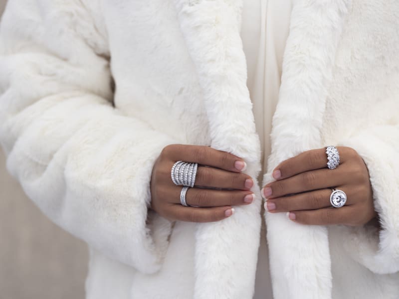 A woman wears silver diamond rings. 