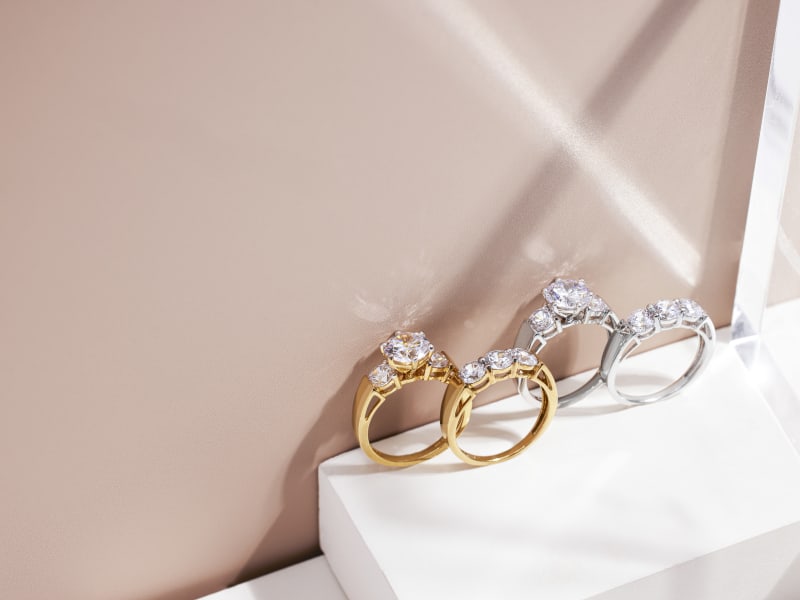 two gold and silver, white gemstone rings 