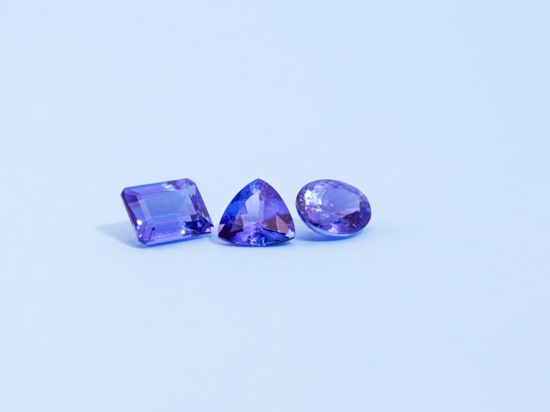 A trio of loose tanzanite stones with different shapes and cuts 