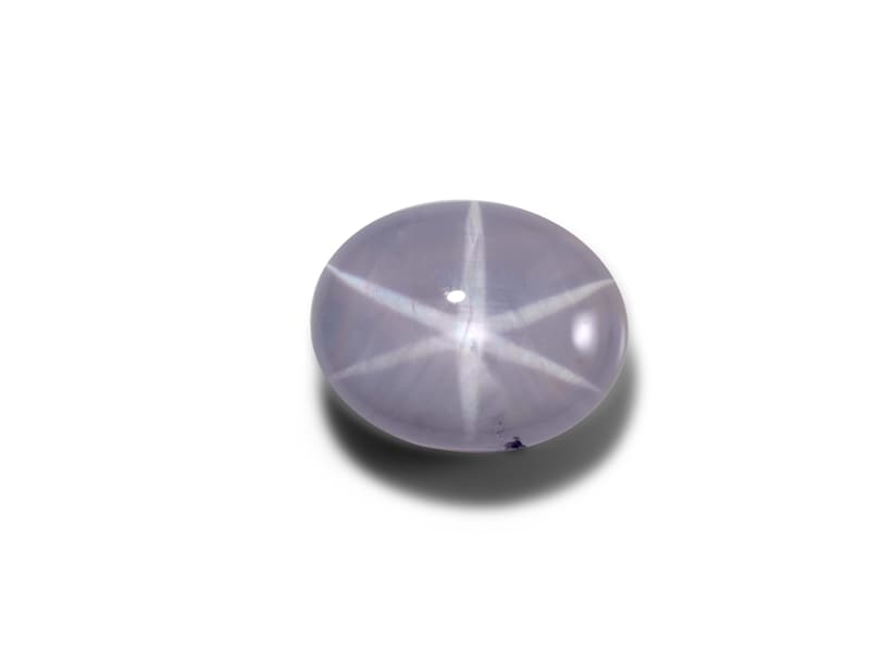 Star sapphire that reflects the shape of a star on its surface 
