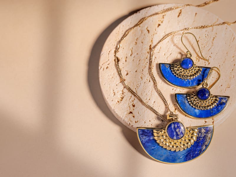 A set of gold lapis lazuli earrings and a matching necklace 