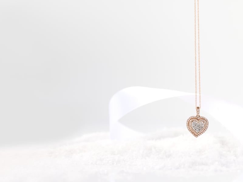 A gold and diamond heart pendant necklace 
