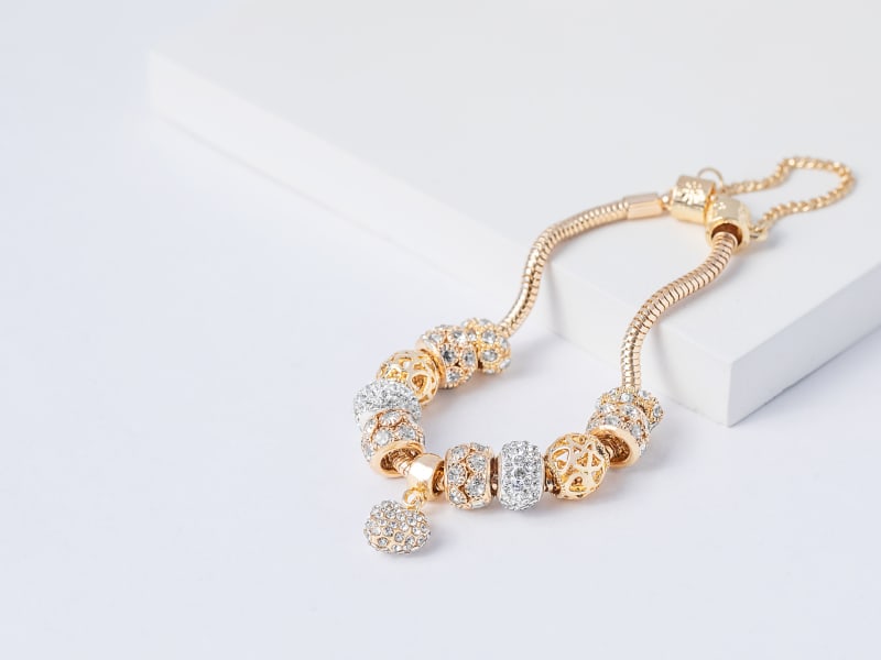 A silver and gold charm bracelet 