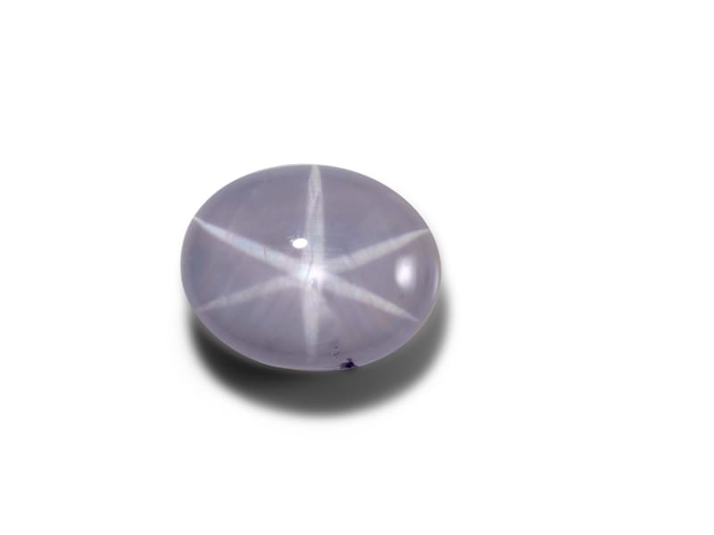 Star sapphire that reflects the shape of a star on its surface 