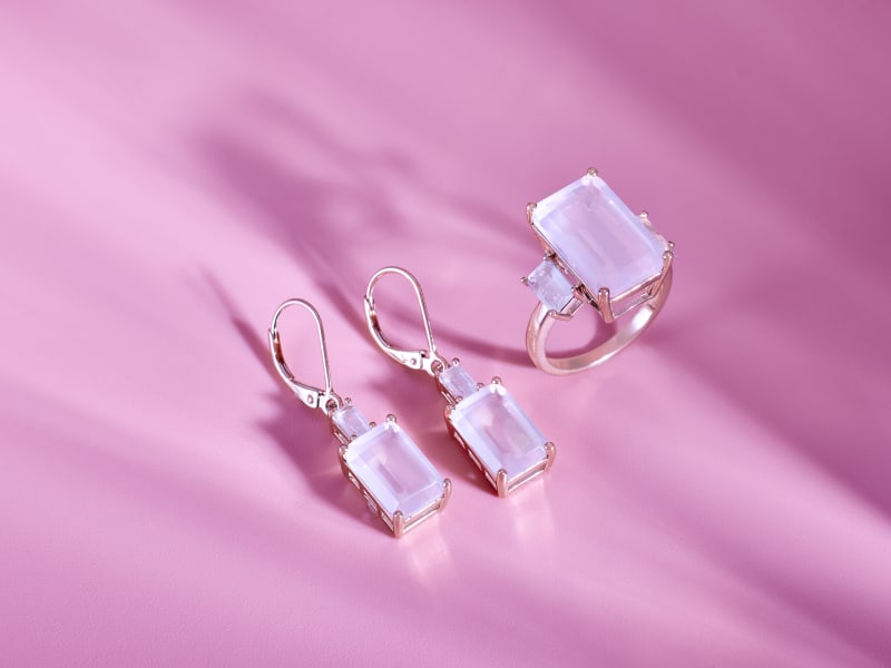 A matching pair of rose gold earrings and a rose gold ring 