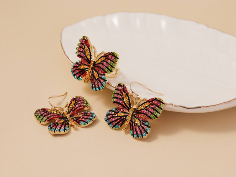 A matching set of multicolor butterfly-shaped earrings and a ring 