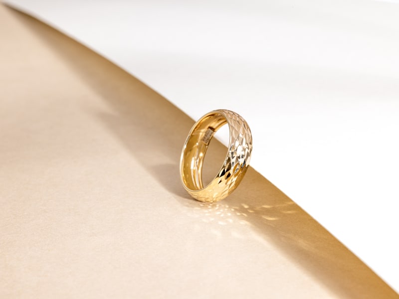 A textured gold band ring 