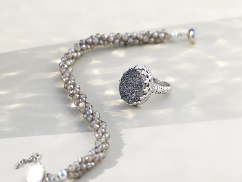 A drusy quartz ring and a gray beaded bracelet 
