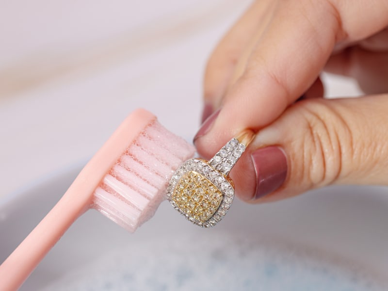 brushing a diamond ring with a soft bristle brush 