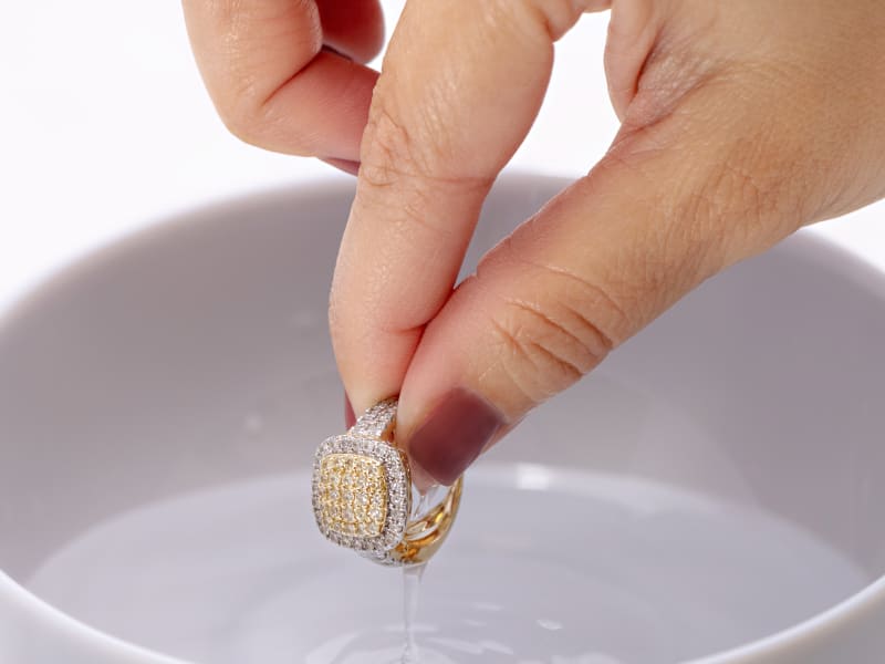 Rinsing a diamond ring in warm water 