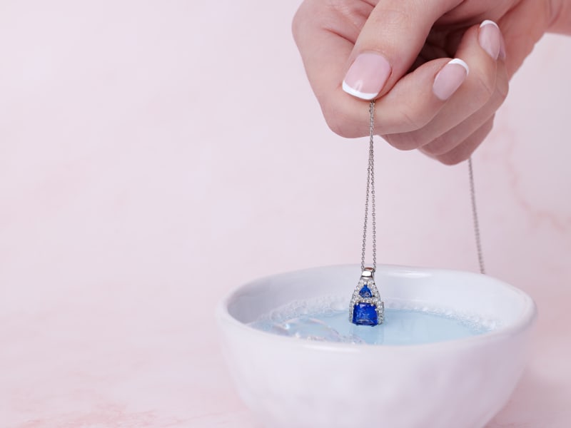 soaking tanzanite jewelry in warm, soapy water 