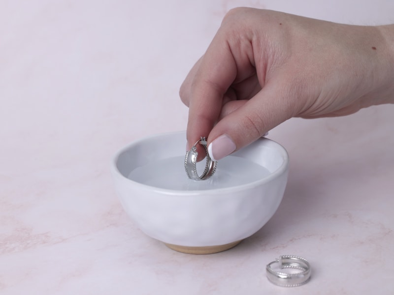 Rinsing jewelry in warm water 